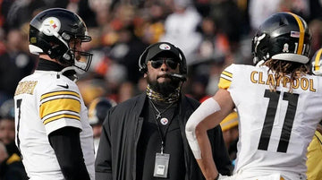 Pittsburgh Steelers coach and players in white uniforms on the field during a football game
