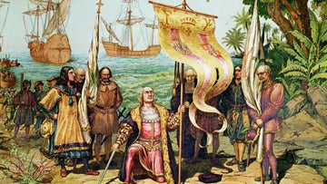 Historic painting of Christopher Columbus kneeling with a flag on shore, ships in the background, surrounded by crew and tropical trees